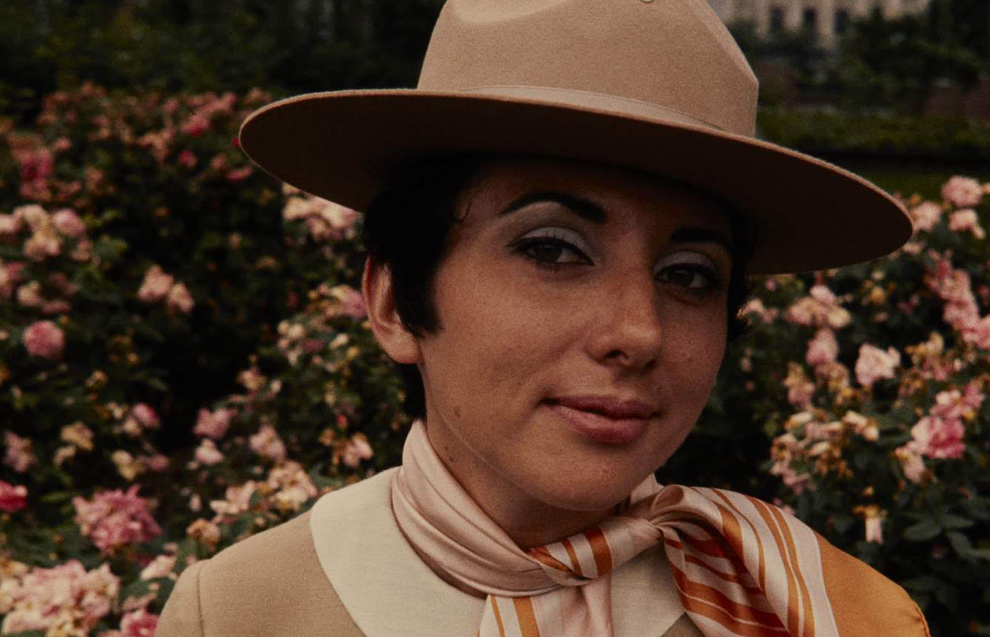 Carol Scanlon models the beige NPS women’s uniform dress, scarf, and broad brim hat. The uniform has an arrowhead patch instead of a ranger badge.